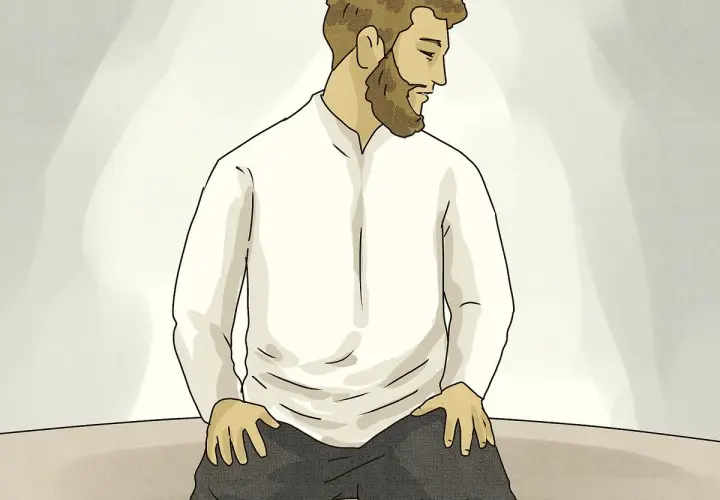 Man med skägg sitter på knä, redo för Asr-bönen.